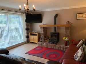 a living room with a fireplace and a couch at Parkside Mews in Frizington