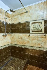 a bathroom with a shower with brown tile at Guest house Nikolaevsky in Bilhorod-Dnistrovskyi +94 photos