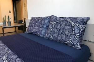 a blue bed with a pillow on top of it at Hitech Appartment in Amaliás