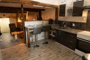 a kitchen with a sink and a counter top at Maison Andree in Fresnes-sur-Apance