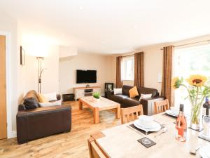 a living room with a couch and a table at 5 The Old Sawmill in Warcop