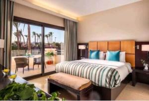 a bedroom with a bed and a balcony with a table at غرفة سنجل سي فيو in Sharm El Sheikh +9 photos