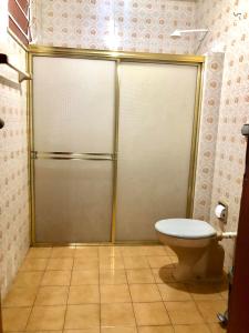 a shower stall with a toilet in a bathroom at Hotel Fortaleza Manaus in Manaus