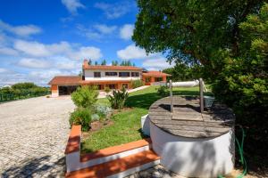 a house with a water fountain in front of it at Greenside of Sea Hostel in Corujeira