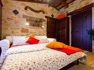 a bedroom with a bed with colorful pillows on it at Sun Garden Premium Apartments in Vrsar