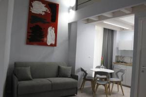 a living room with a couch and a table at Valina Apartments in Catania