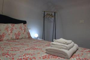 a bedroom with a bed with towels on it at Valina Apartments in Catania
