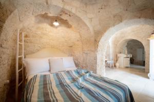 A bed or beds in a room at WePuglia - Trulli Brillina