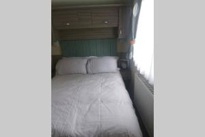 a bed in the back of a trailer at Hoburne Devon Bay Static 3 Bed in Goodrington