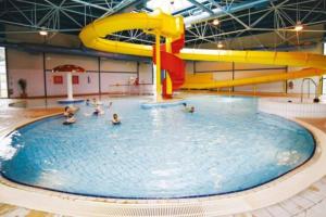 a pool with people in it with a water slide at Hoburne Devon Bay Static 3 Bed in Goodrington