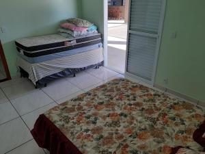 A bed or beds in a room at Recanto dos Sonhos