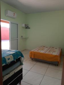 A bed or beds in a room at Recanto dos Sonhos