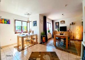 a living room with a table and a dining room at Karibu in Tiefenthal