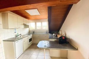 a kitchen with a sink and a counter top at *Dreiländereck* Wifi+ Balkon+Garage Basel Mulhouse in Maulburg