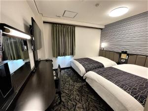 Postel nebo postele na pokoji v ubytování APA Hotel Hachioji Eki Nishi