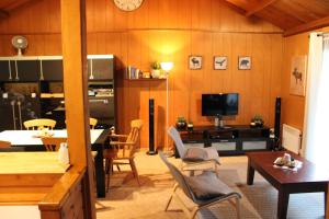a living room with a kitchen and a dining room at Chalet Ardennais 240 - La Boverie - Rendeux in Rendeux