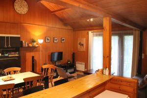 a kitchen and dining room with a large wooden table at Chalet Ardennais 240 - La Boverie - Rendeux in Rendeux