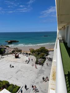 a view of the beach from the balcony of a building at T3 Bis - 4 Etoiles Rooftop et Vue Mer - Bellevue Biarritz in Biarritz