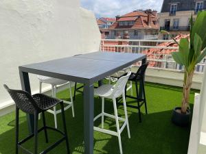 a blue table and chairs on a balcony at T3 Bis - 4 Etoiles Rooftop et Vue Mer - Bellevue Biarritz in Biarritz +5 photos