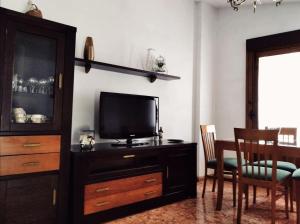 a living room with a television on a dresser at La casa de Tentenecio in Salamanca