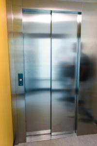 a metal elevator door in a building at City center 1R studio with perfect view, parking in Oulu