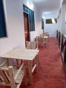 a row of tables and chairs in a room at New Iddi Villa in Jambiani