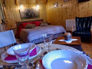 um quarto com uma cama e uma mesa com pratos e copos em La Cabane de Cécile-la Hutte em Étretat