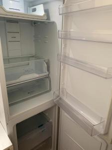 an empty refrigerator with its door open and its at City center - Unirii studio in Bucharest
