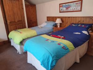 two beds sitting next to each other in a bedroom at The Coach House Holiday Cottage, Southport in Southport