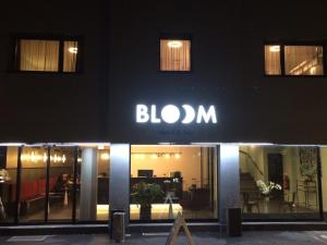 a building with a sign on the side of it at BLOOM Boutique Hotel & Lounge Basel in Basel
