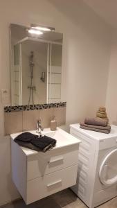a white bathroom with a sink and a toilet at Nathan Home in Saint-Jean-de-Blaignac