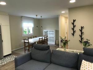 a living room with a couch and a dining room at Casa Otilia - Rural - Camino de Santiago - Arzúa in Arzúa