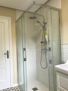 a shower in a bathroom with a glass shower stall at Casa Otilia - Rural - Camino de Santiago - Arzúa in Arzúa +62 photos