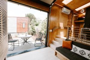 a room with a balcony with a table and chairs at Ironwood Grove, Tiny House Hotel in Nashville