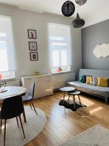a living room with a couch and a table at STUDIO 18 in Sopron