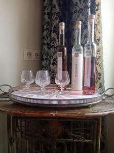 three wine bottles and wine glasses on a table at Ferienwohnung Sunna in Lieser