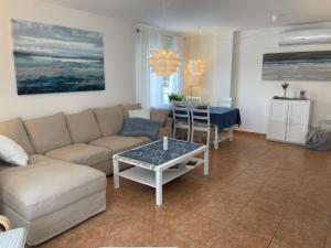 a living room with a couch and a table at WohnungAltea - Kirche, Berge, am Meer in Altea