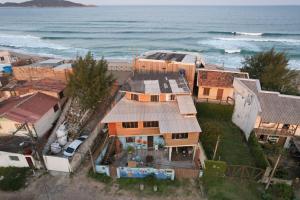 an aerial view of a house next to the ocean at Hostel Aroeira do campo in Florianópolis