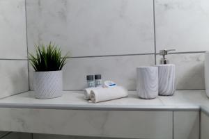 a bathroom counter with two towels and a sink at Sunset brand new luxury apt with pool & sea view in Karpathos