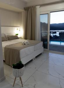 A bed or beds in a room at Sunset brand new luxury apt with pool & sea view