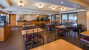 a restaurant with tables and chairs and a cafeteria at Best Western East Towne Suites in Madison