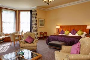 a hotel room with a bed and a table and chairs at Best Western Balgeddie House Hotel in Glenrothes +33 photos