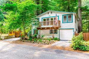 ein Haus mit einer Veranda und einer Terrasse mit einer Garage in der Unterkunft Creek House in Guerneville