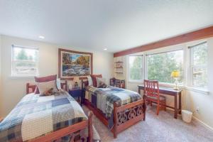a bedroom with two beds and a desk and windows at Valley Perch in Sun Valley +56 photos