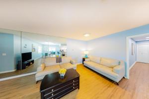 a living room with two couches and a tv at Dana Shores Retreat in Tampa