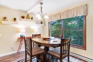 a dining room with a table and chairs and a window at Casa Bee Branch in Sugar Mountain