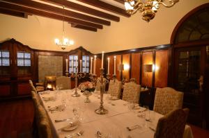 a dining room with a long table and chairs at Welgelegen Manor - Balfour Mpumalanga in Balfour