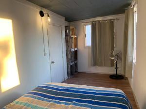 a bedroom with a bed and a window in it at summer in Maldonado