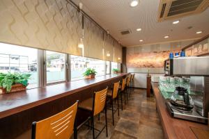 a bar in a restaurant with chairs and a counter at セントラルホテル磯原 in Isohara