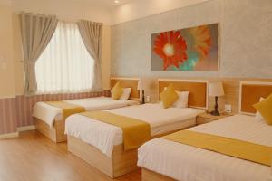 Postel nebo postele na pokoji v ubytování Sao Vang Hotel